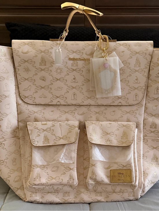 Bath & Body Works Handbags - Bath & Body Works Disney Princess 3 Charms Gold Bow Backpack NWT